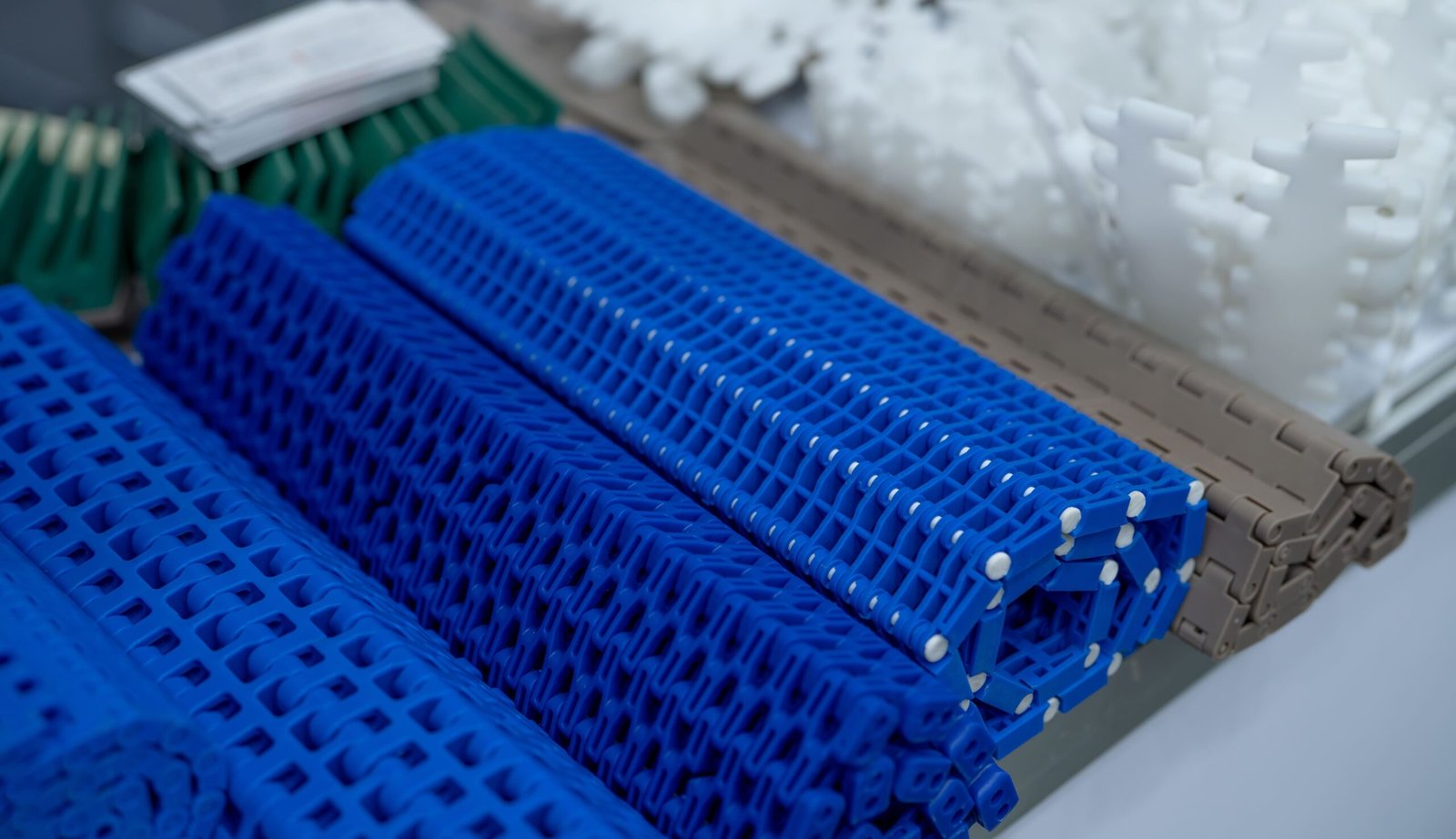 Guide rails and wear strips for conveyor systems